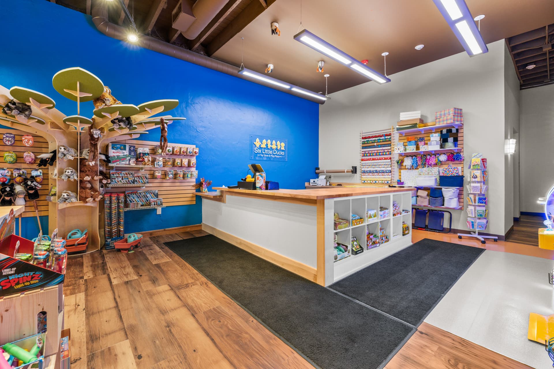 The checkout counter and stuffed-animal tree at Six Little Ducks
