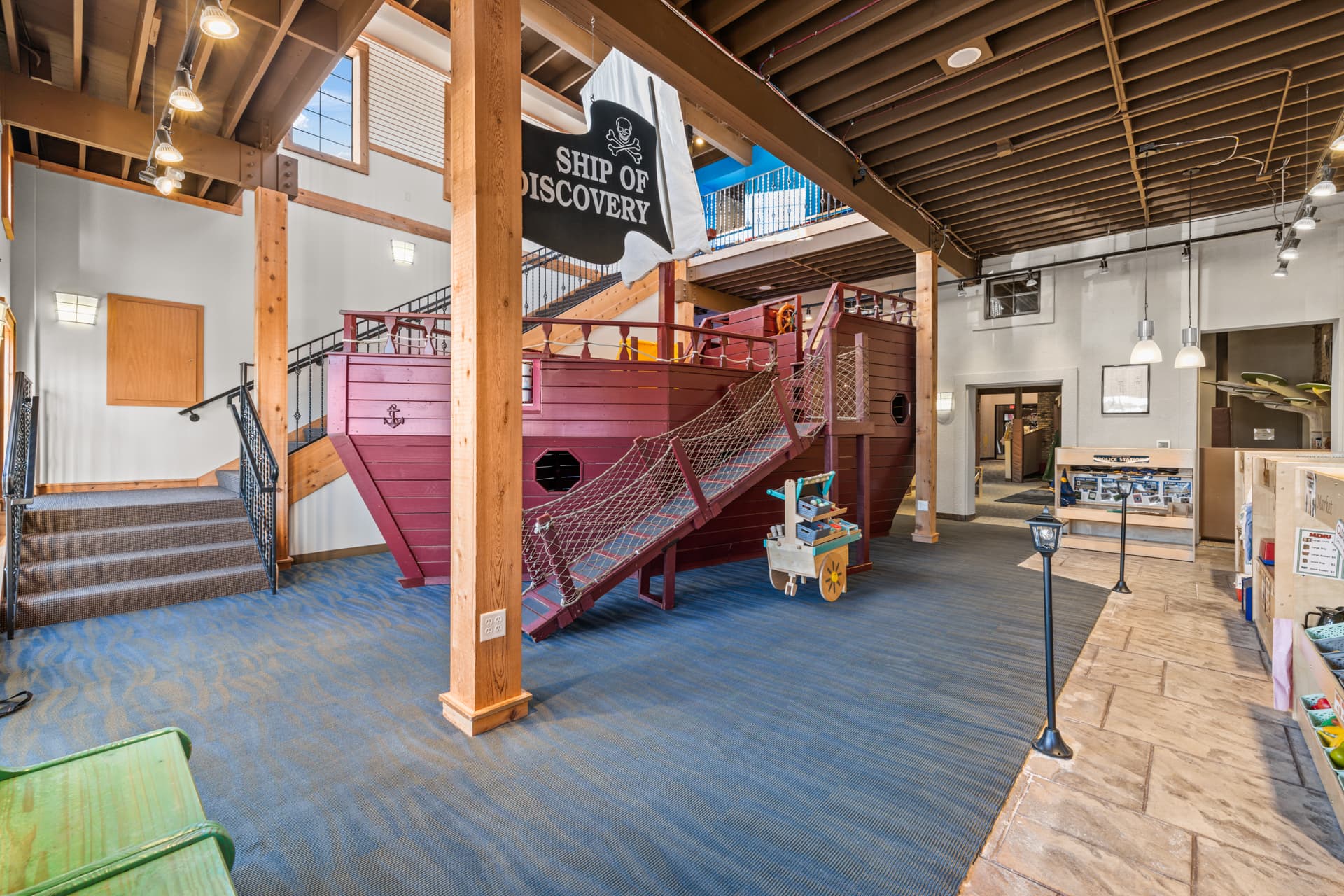 The Ship of Discovery giant playground pirate ship with a rope bridge at Six Little Ducks indoor play space in Oconomowoc