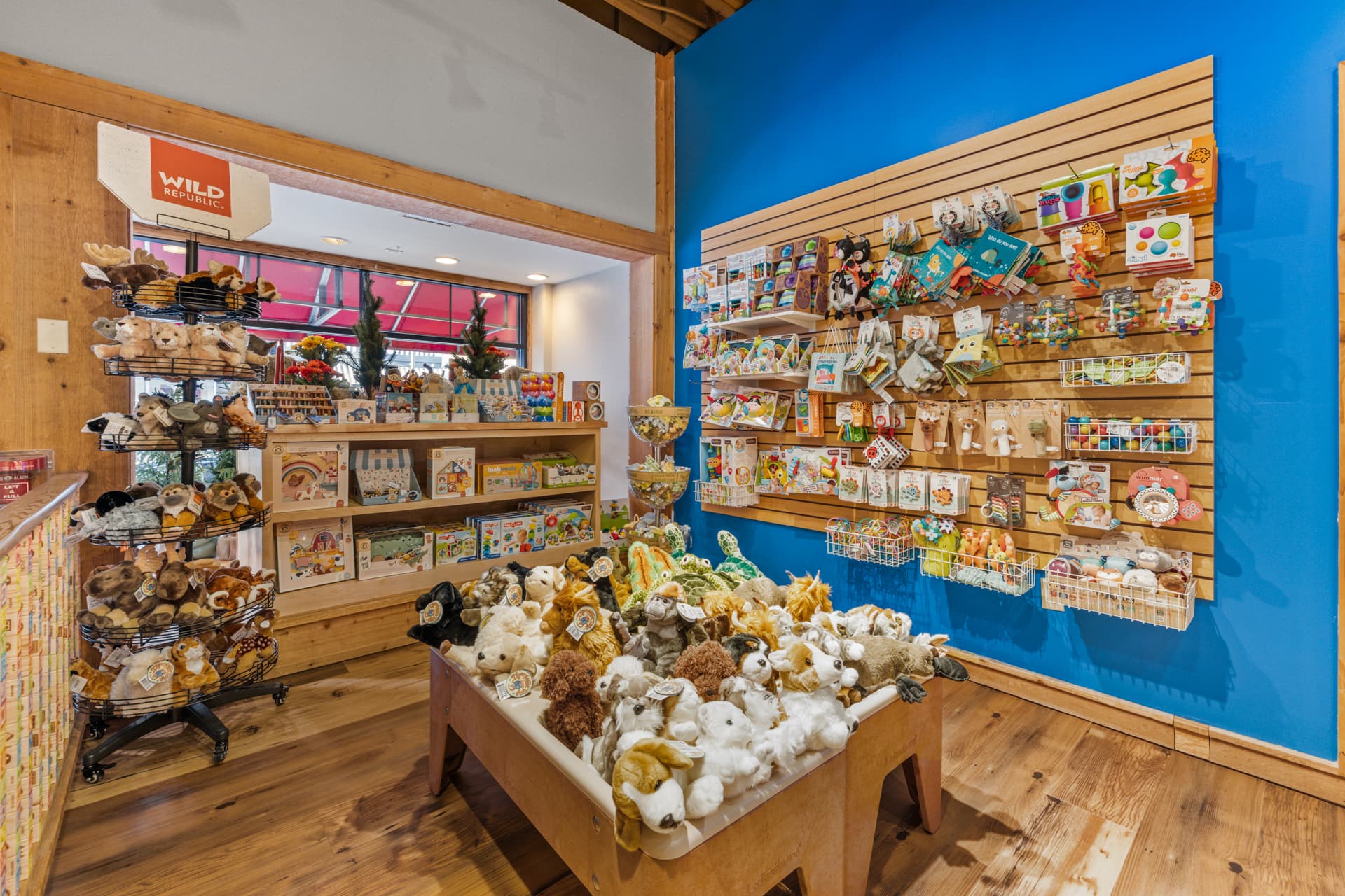 Plush woodland animals and baby toys displayed in the toy store
